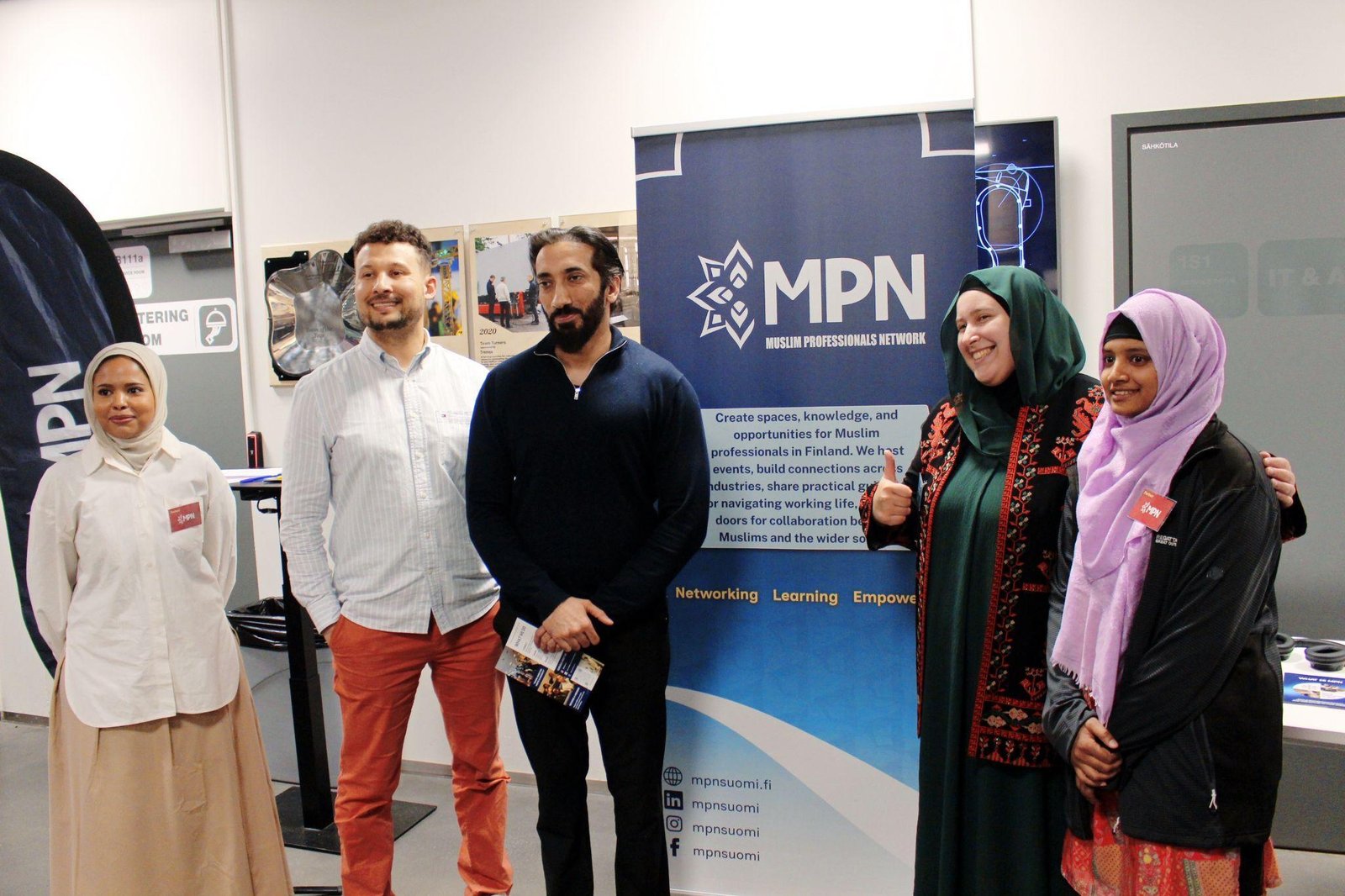 MPN community members gathered beside an MPN banner at the event